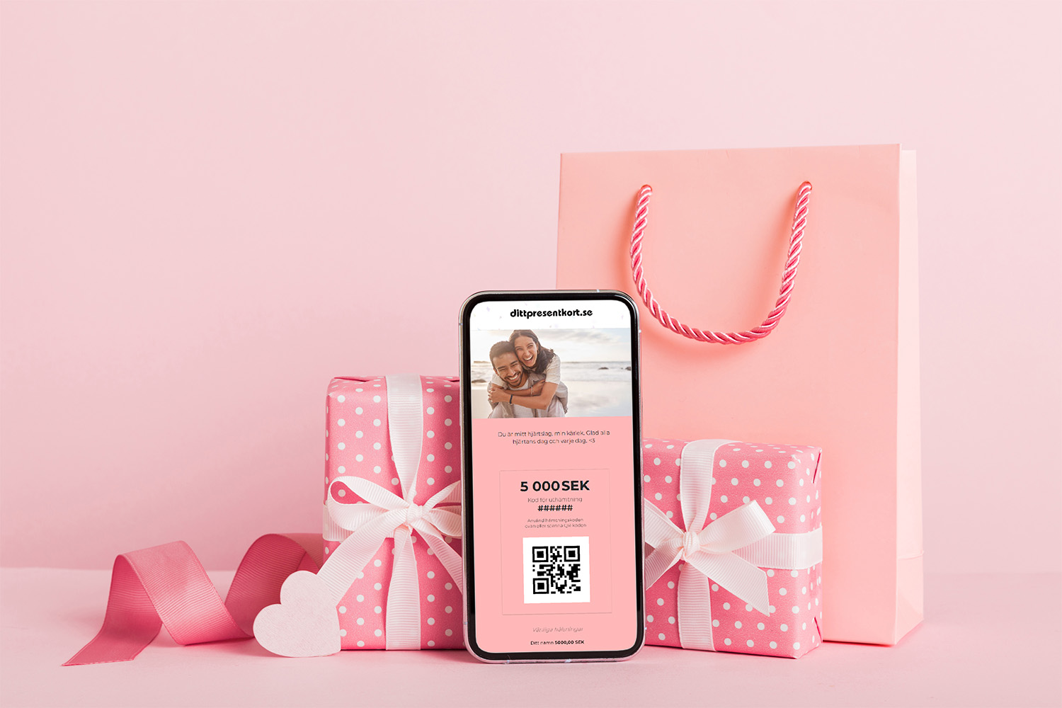 Bild på flera rosa presenter och en telefon som visar ett presentkort