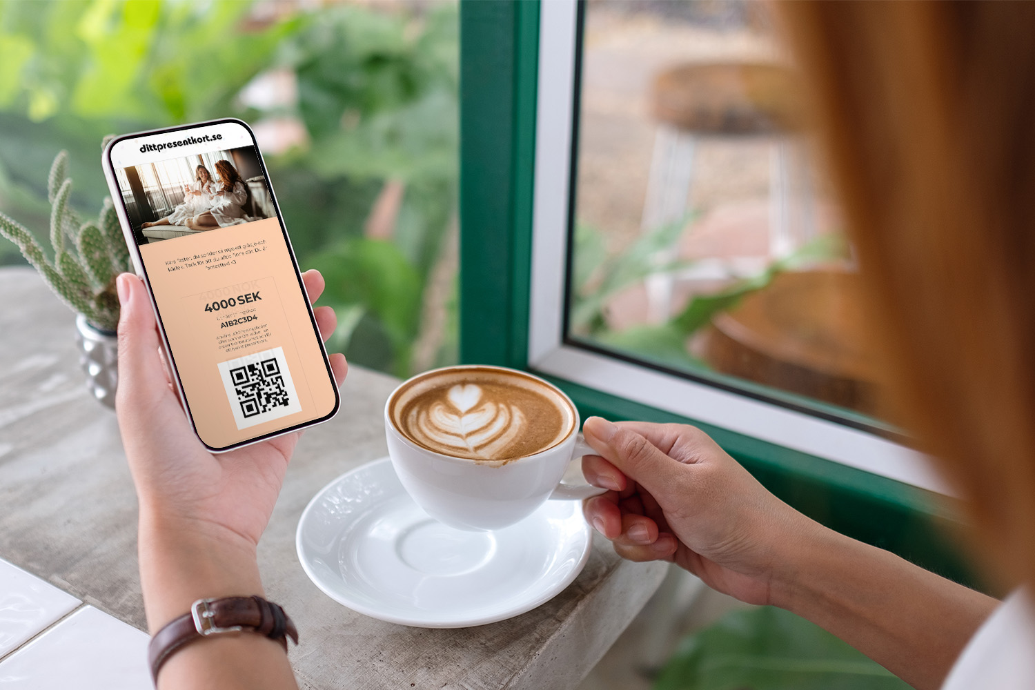kvinna som håller mobiltelefon med dittpresentkort på skärmen medan du dricker kaffe